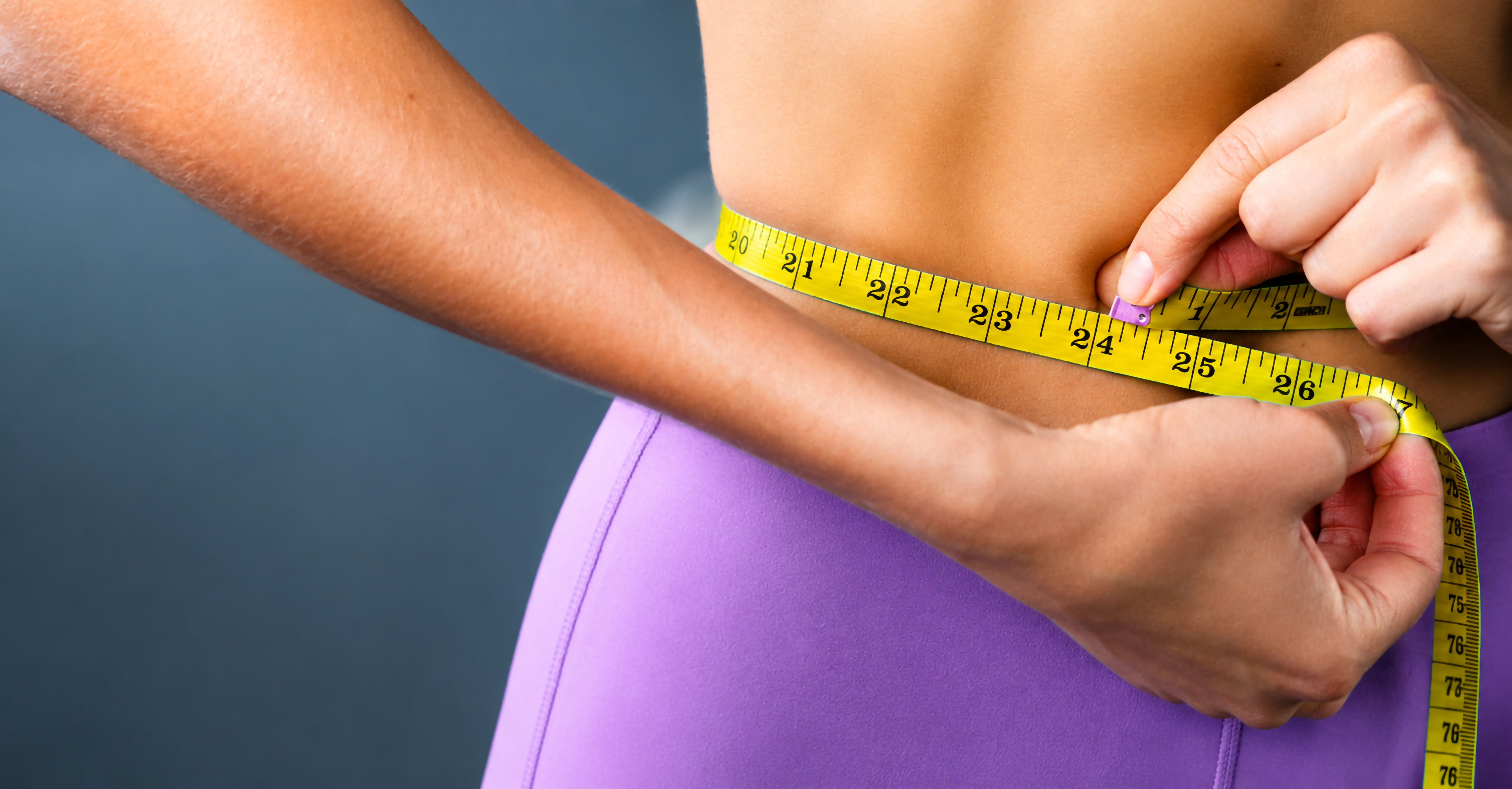 Measuring waist with tape